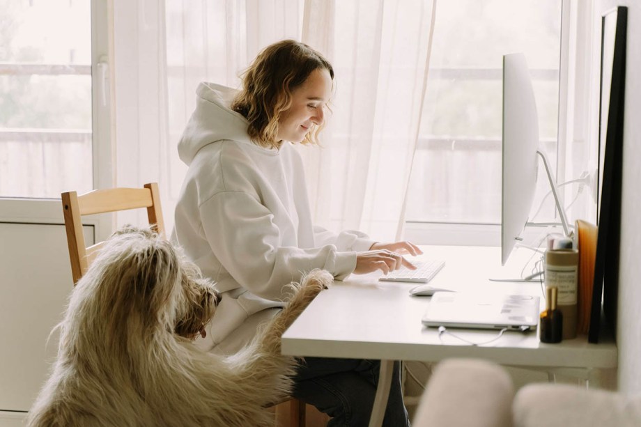 Woman working remotely with her dog
